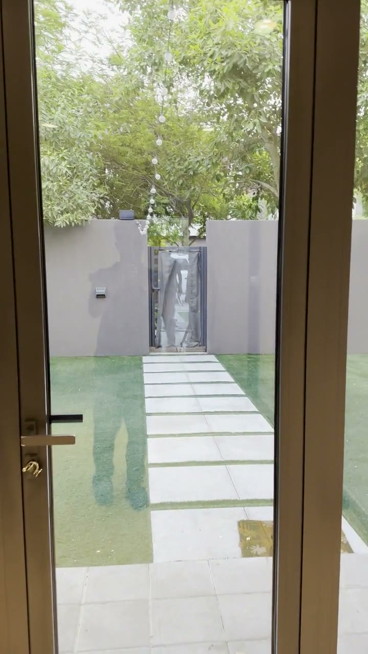 Blick durch die Terrassentuer in den gepflegten Garten